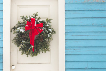 Fototapeta na wymiar Christmas wreath on vintage door