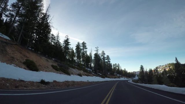 Heading Down Hill on Road Through Bryce Canyon with snow on either side