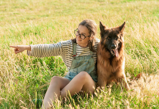 Woman hug her dog German Shepherd in autumn park
