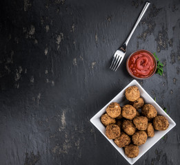Meatballs on a vintage looking slate slab (selective focus)