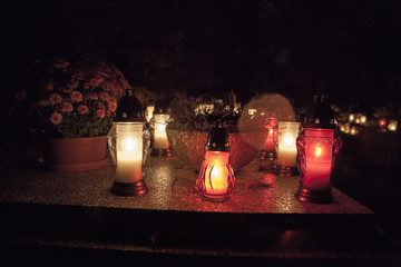 light on the grave at November night