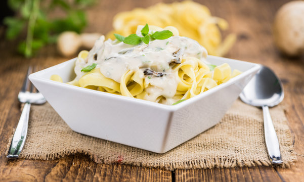 Fresh made Porcini pasta on a rustic background