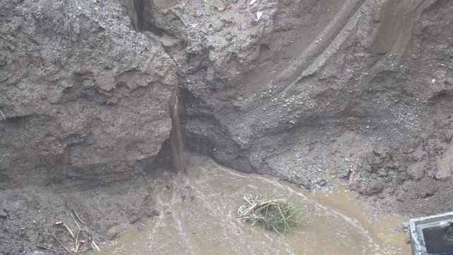 the Creek in the mud after a storm and heavy rain,the dirt spilling from all sides.