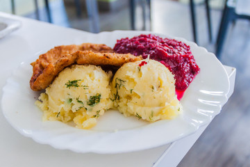 Food in Poland - breaded chicken filet, mashed potatoes and beets