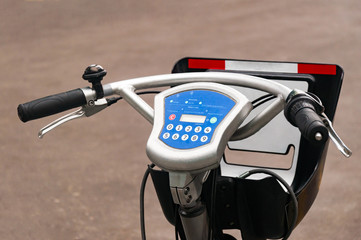 City bike rental system. Bicycle parts are large. Parking bicycles on city streets. With tinting and blurring.