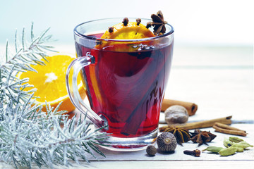 Traditional winter mulled wine with spices and Christmas decor.