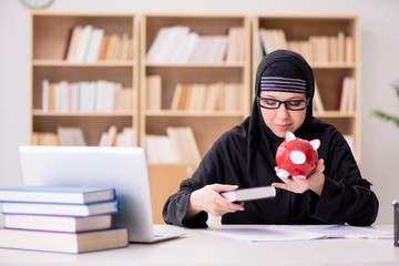 Muslim girl in hijab studying preparing for exams