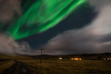 Naklejka na ściany i meble Northern lights Aurora Borealis above landscape in Iceland