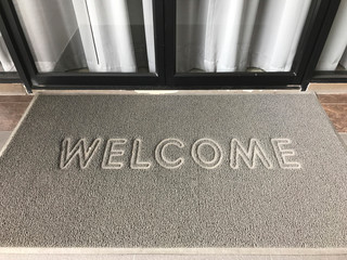 Grunge gray door mat stated Welcome