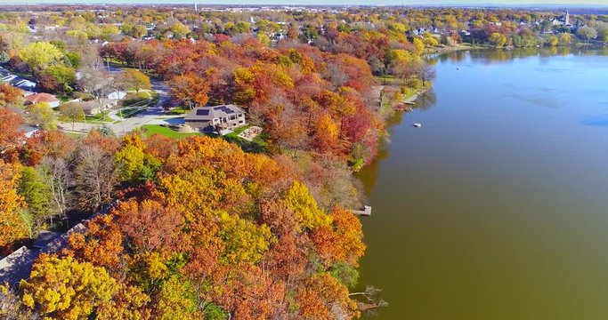 Amazing colorful Autumn trees along riverside, small town, Wisconsin.

