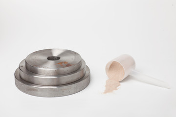 Obraz na płótnie Canvas steel rusty dumbbell weights with protein scoop isolated on white background