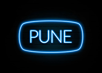 Pune  - colorful Neon Sign on brickwall