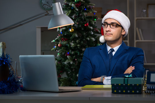 Businessman working late on christmas day in office