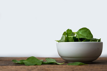 cup of spinach on wooden table