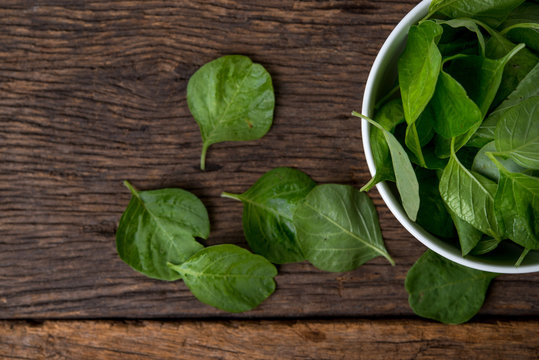 cup of spinach on wooden table