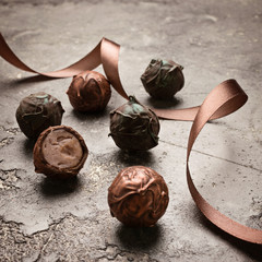 A set of chocolates from different chocolate lies on a gray background. Assorted milk and dark...