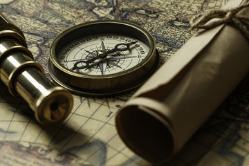 Retro compass with old map and spyglass