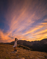 Girl Watches Sunset in the Mountains