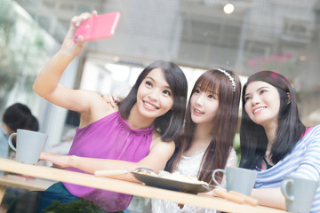 happy woman friends in restaurant