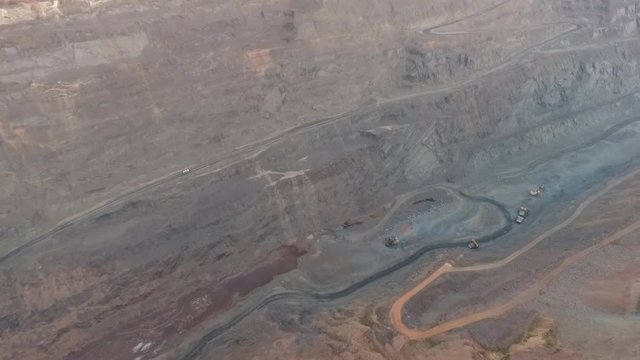Open pit mine working machinery trucks aerial footage