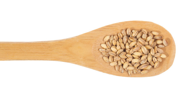 Grains over wooden bamboo spoon. Isolated, White background.