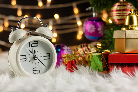 Christmas Retro alarm clock.decoratied with gift box and fir festive on blurred bokeh background.Celebration and Happy New Year Concept.