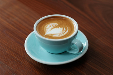 Coffee cup on wood table background with copy space