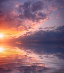 Fototapeta premium Dawn on a spring day and beautiful bright clouds over the sea.