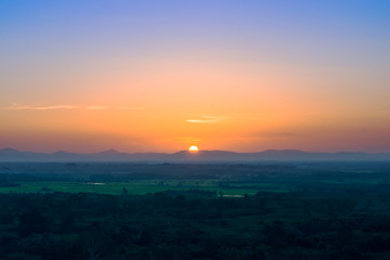 Sunset sky and big sun with mountain.