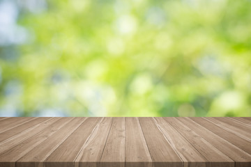 Wood table top on nature green blurred background,for montage your products