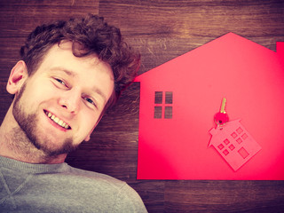 Man lying with house symbols.