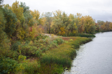 Fototapeta na wymiar Beautiful autumn landscape with colorful trees. Ukrainian riverband
