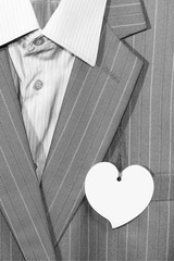 Business men's gray suit with a price tag in the form of a heart
