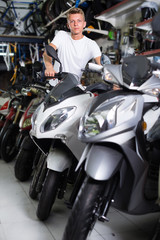 Fototapeta na wymiar Male is choosing new motorcycle