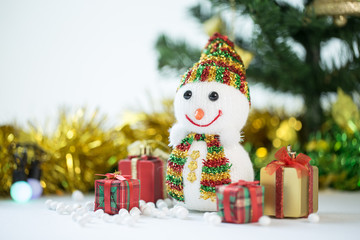 Snowman Standing with Gift Box on bokeh background. Christman Concept.