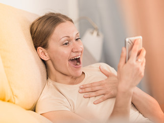 Laughing woman with phone