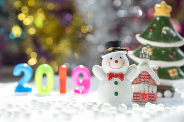Snowman Standing with Gift Box on bokeh background. Christman Concept.