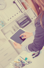 Hands of businesswoman using tablet