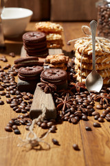Aroma coffee candy chocolate cookies and spices on the wooden table. Christmas sweets. Dark wooden background. Top view. Close. Closeup.