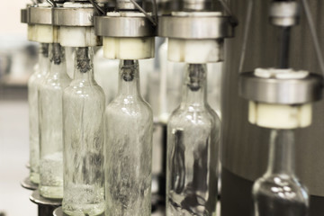 Filling glass bottles with liquid.