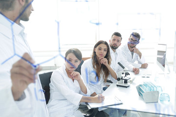 Fototapeta premium view through the transparent Board. a scientist makes a report.