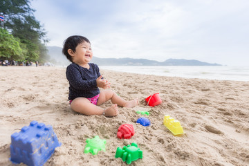 Adorable asian cute girl smiling and happy on the beach