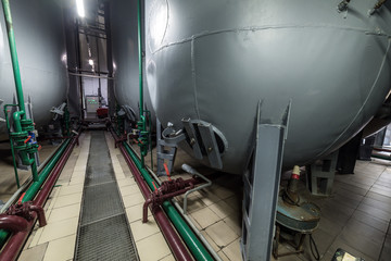 Steel semicircular gray tanks for fermenting the yeast mixture.