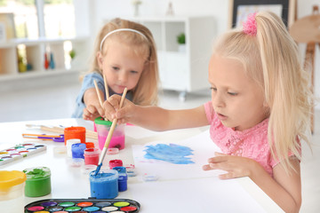 Children at painting lesson in classroom