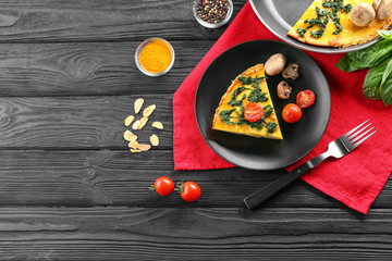 Piece of tasty frittata with spinach on plate