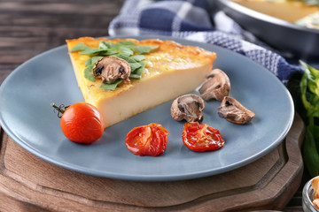 Piece of tasty frittata with spinach on plate