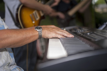 Musician's hands on electric keyboard