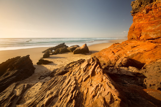 Praia da Bordeira, Algarve, Portugal. Red stone.