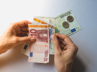 Money of Euro in hands. Detail of woman hands with money, euro notes.
