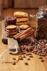 Aroma coffee candy chocolate cookies and spices on the wooden table. Christmas sweets. Dark wooden background. Top view. Close. Closeup.